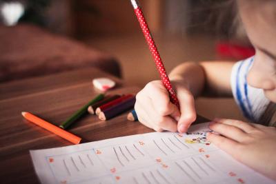 Child scribbling in book